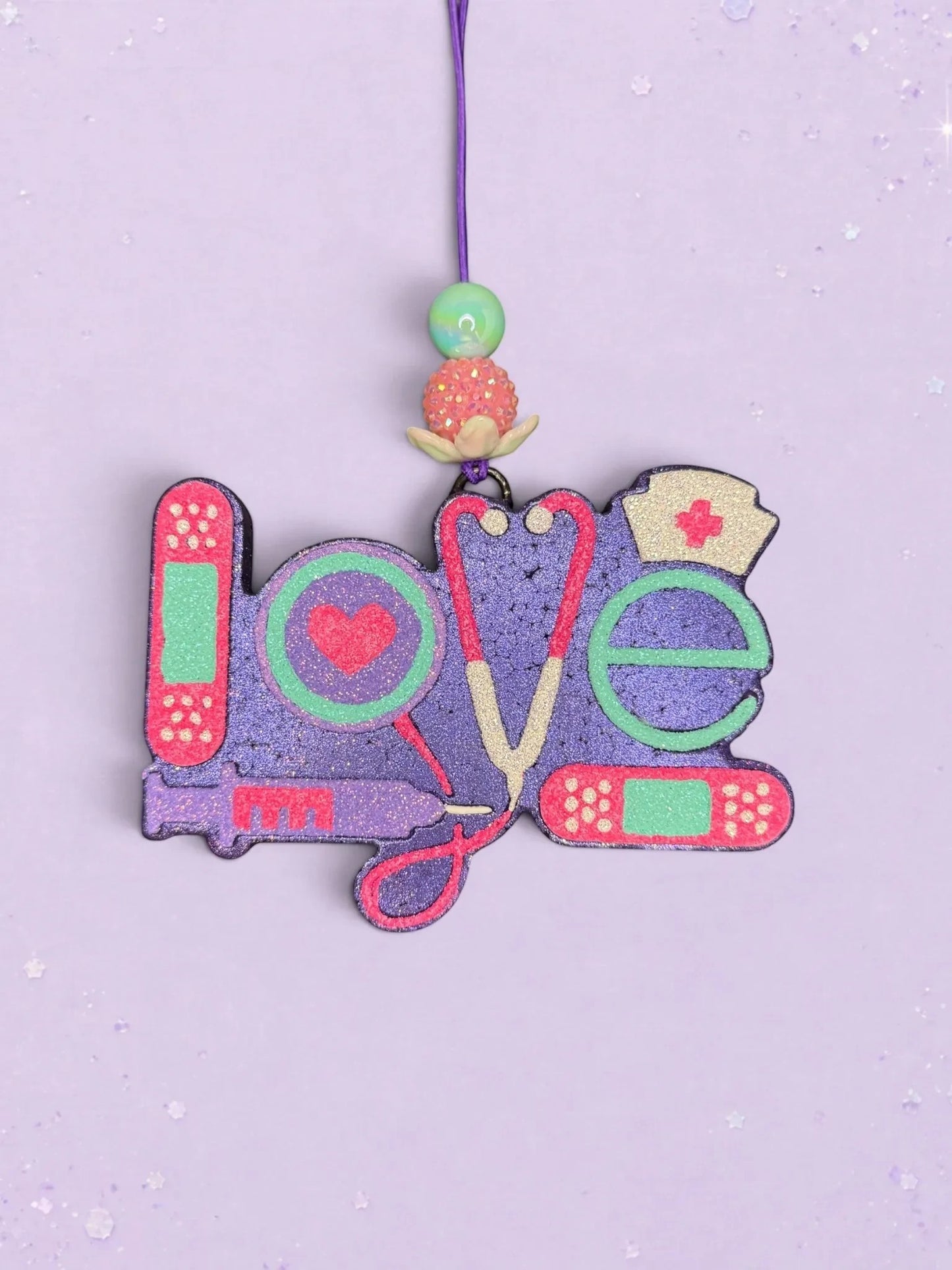 BeFreshie Love Medical Theme freshie featuring purple glitter text with stethoscope, bandage, and nurse hat accents.