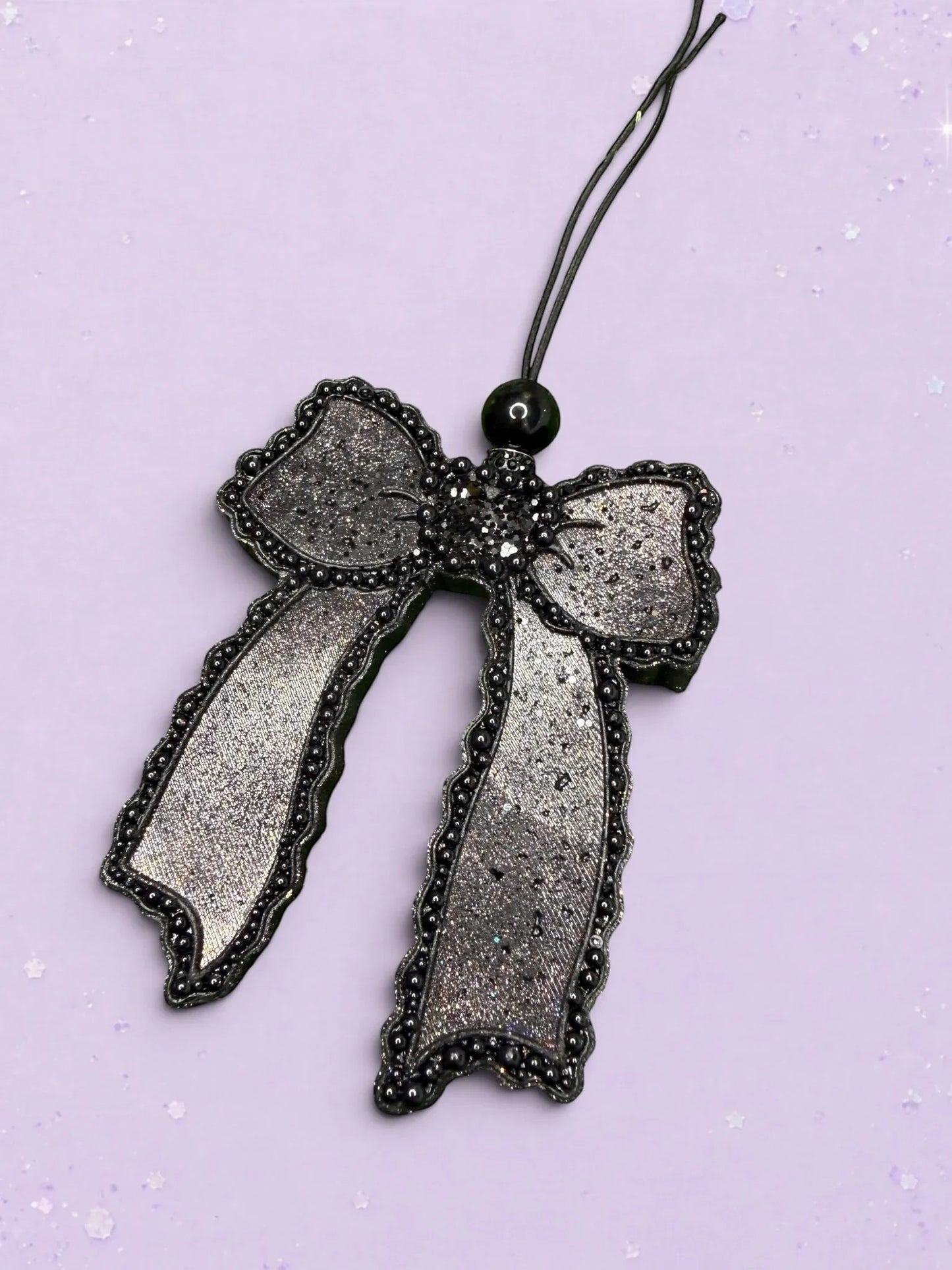 BeFreshie Scallop Bow long tails car freshie in shimmering black with beaded scalloped edges on a lavender background