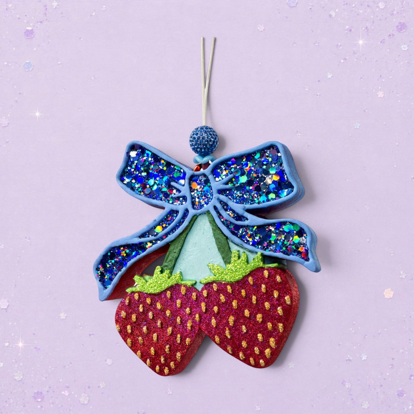 BeFreshie blue glitter bow with two red glitter strawberries hanging below. Feminine car charm.