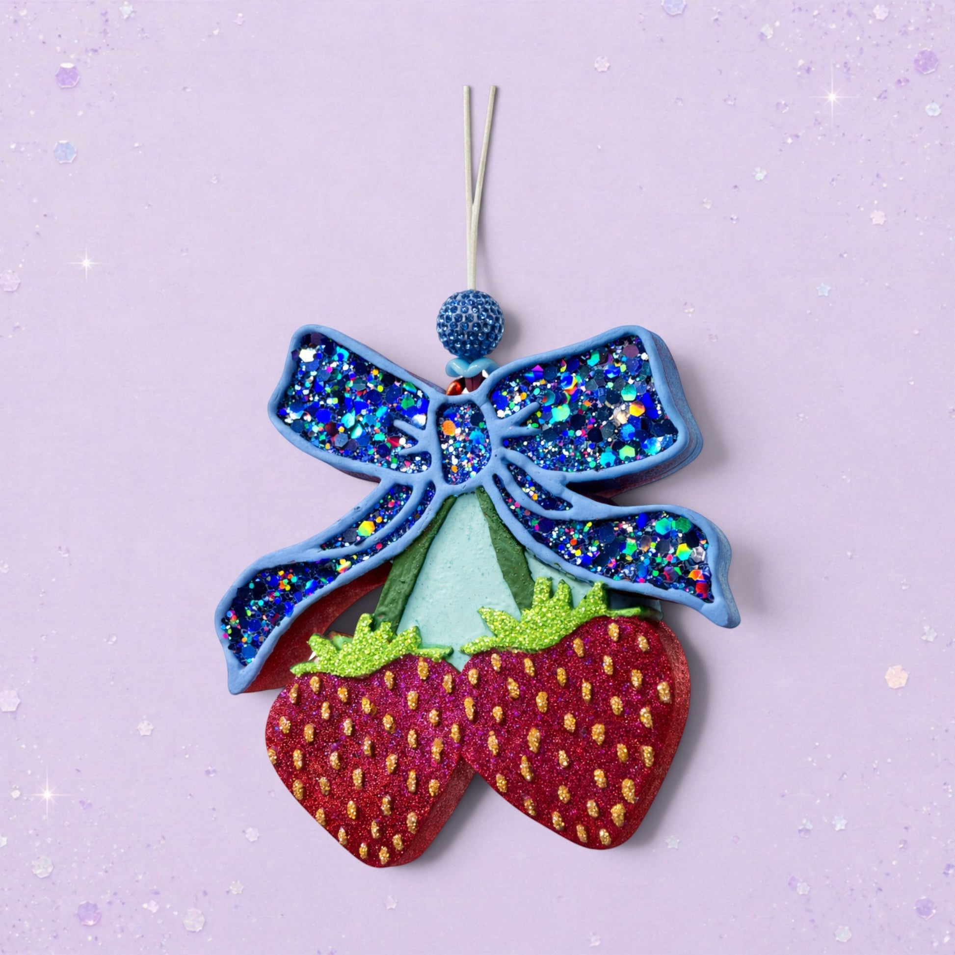 BeFreshie blue glitter bow with two red glitter strawberries hanging below. Feminine car charm.