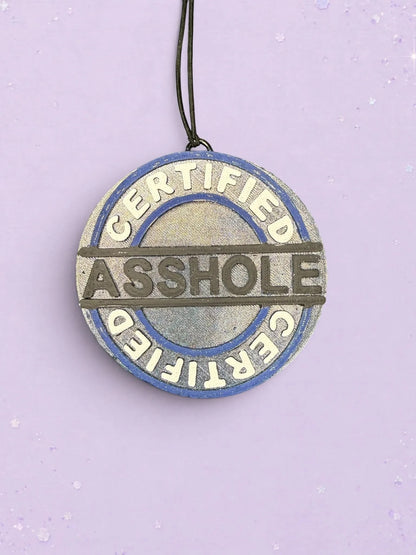 BeFreshie Certified Asshole car air freshener in a round blue and silver design with bold embossed lettering.