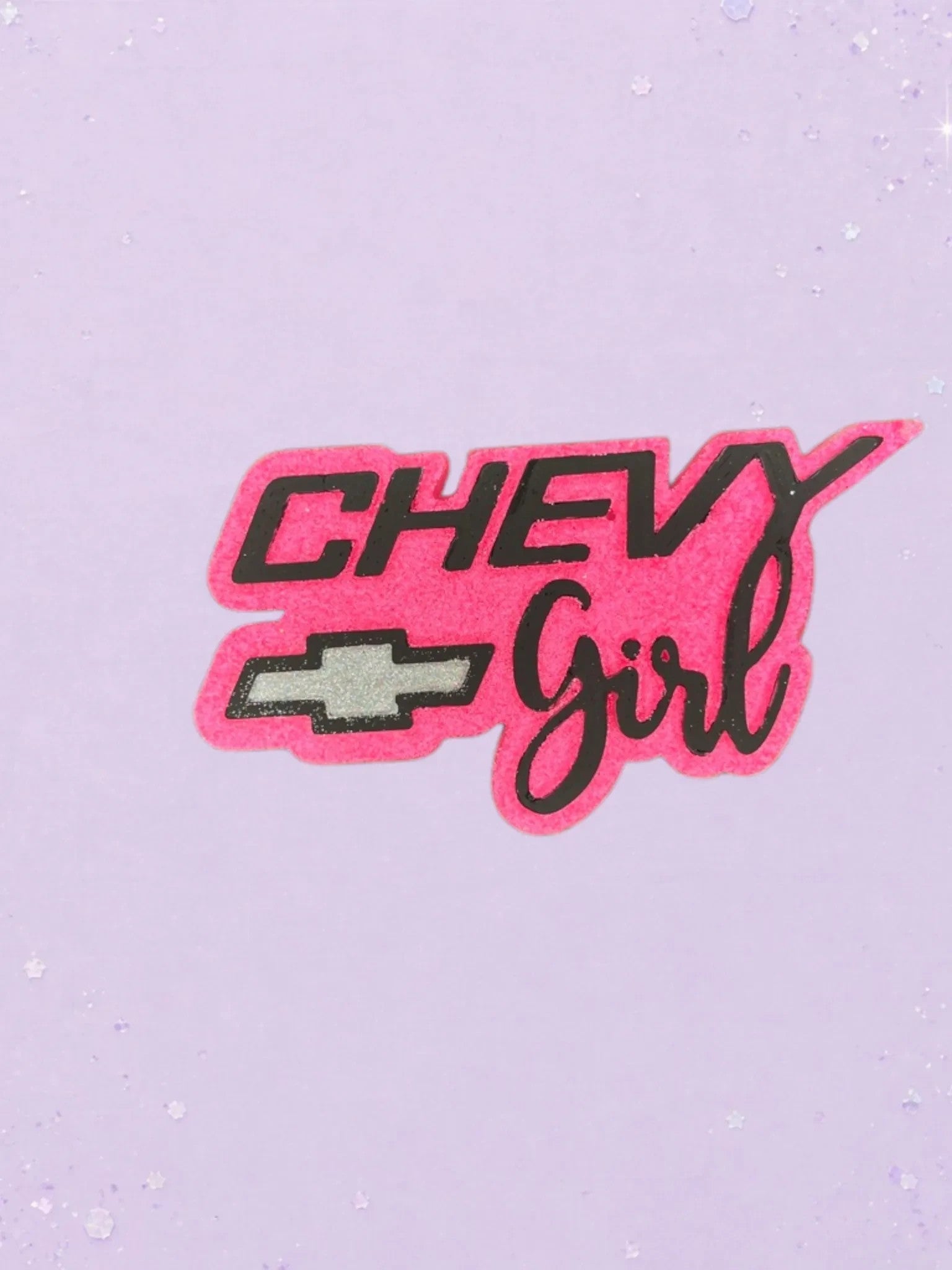 BeFreshie Chevy Girl car air freshener in hot pink and black with a silver Chevrolet logo on a light purple background