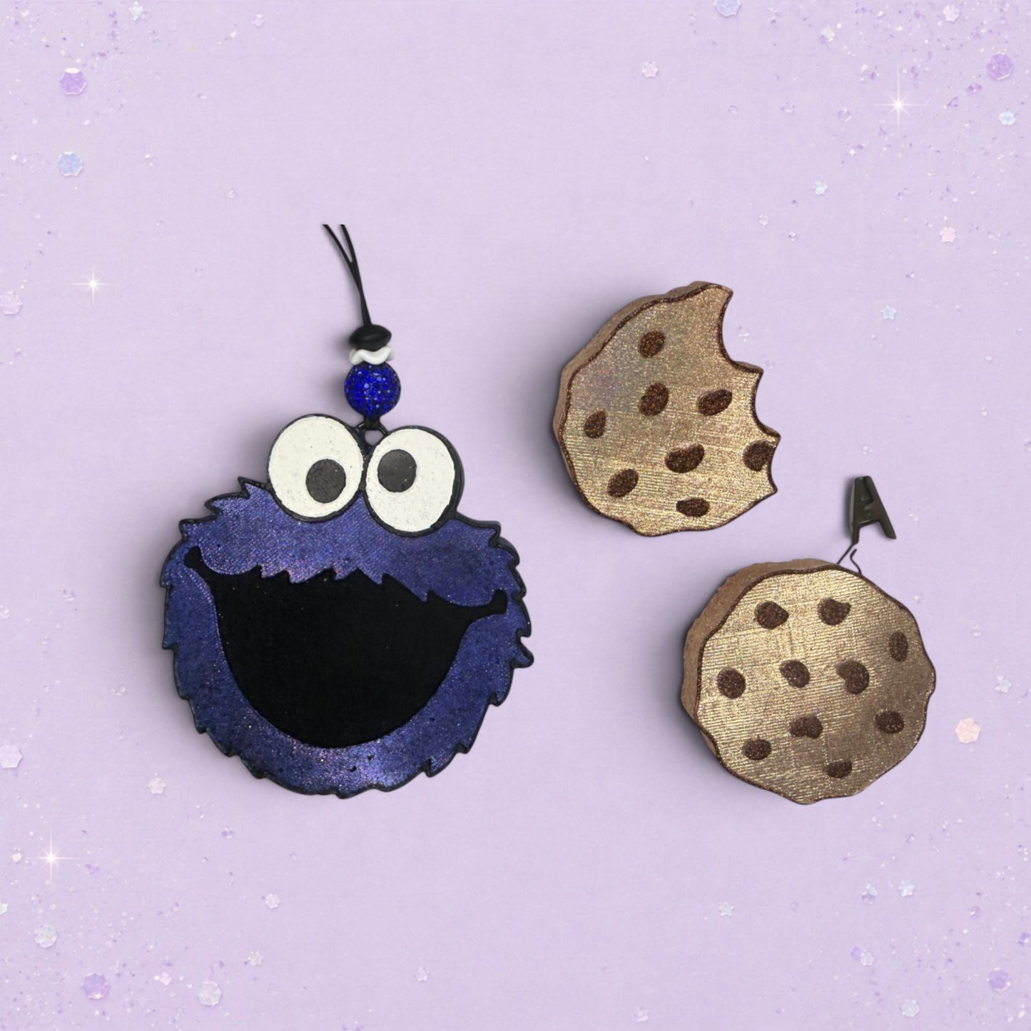 BeFreshie Cookie Monster freshie with blue fuzzy body, googly eyes, and two chocolate chip cookies.