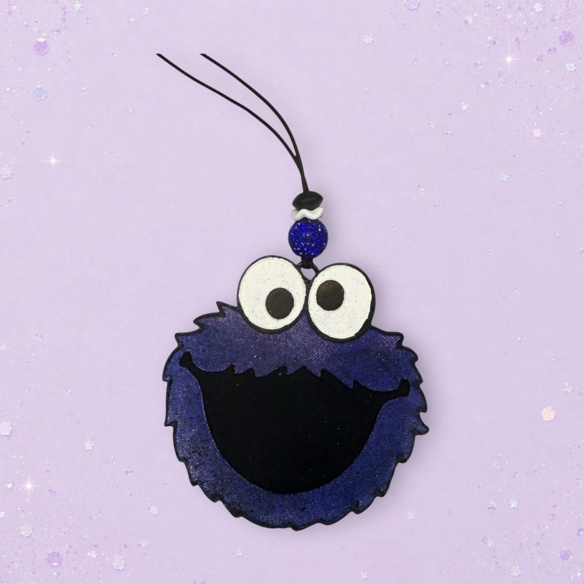 BeFreshie Cookie Monster freshie with blue fuzzy texture, black mouth, and googly eyes. Includes a blue beaded charm and hanging string.