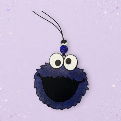 BeFreshie Cookie Monster freshie with blue fuzzy texture, black mouth, and googly eyes. Includes a blue beaded charm and hanging string.