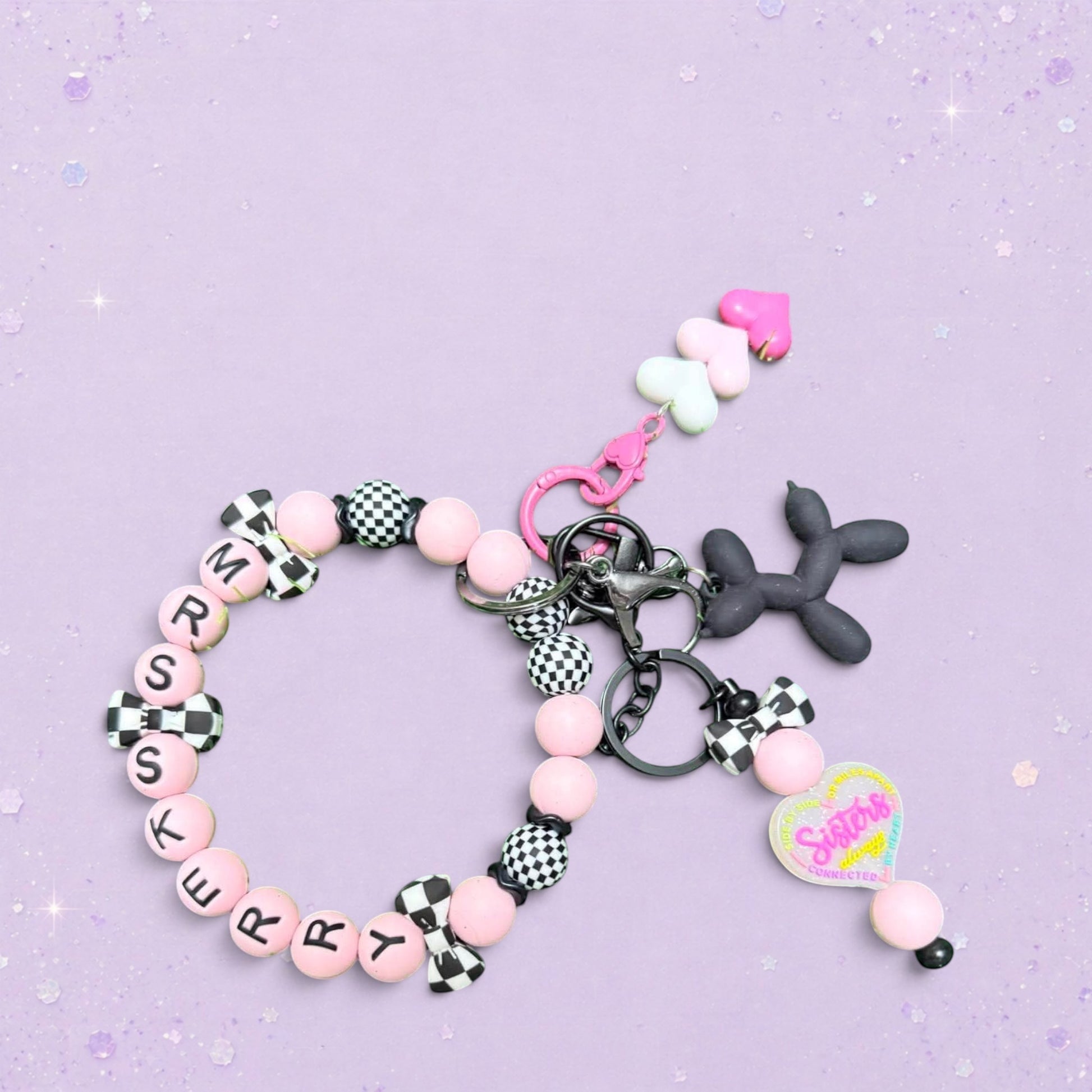 BeFreshie custom beaded keychain with pink beads, checkered charms, and a balloon dog charm. Reads "MRS KERRY".