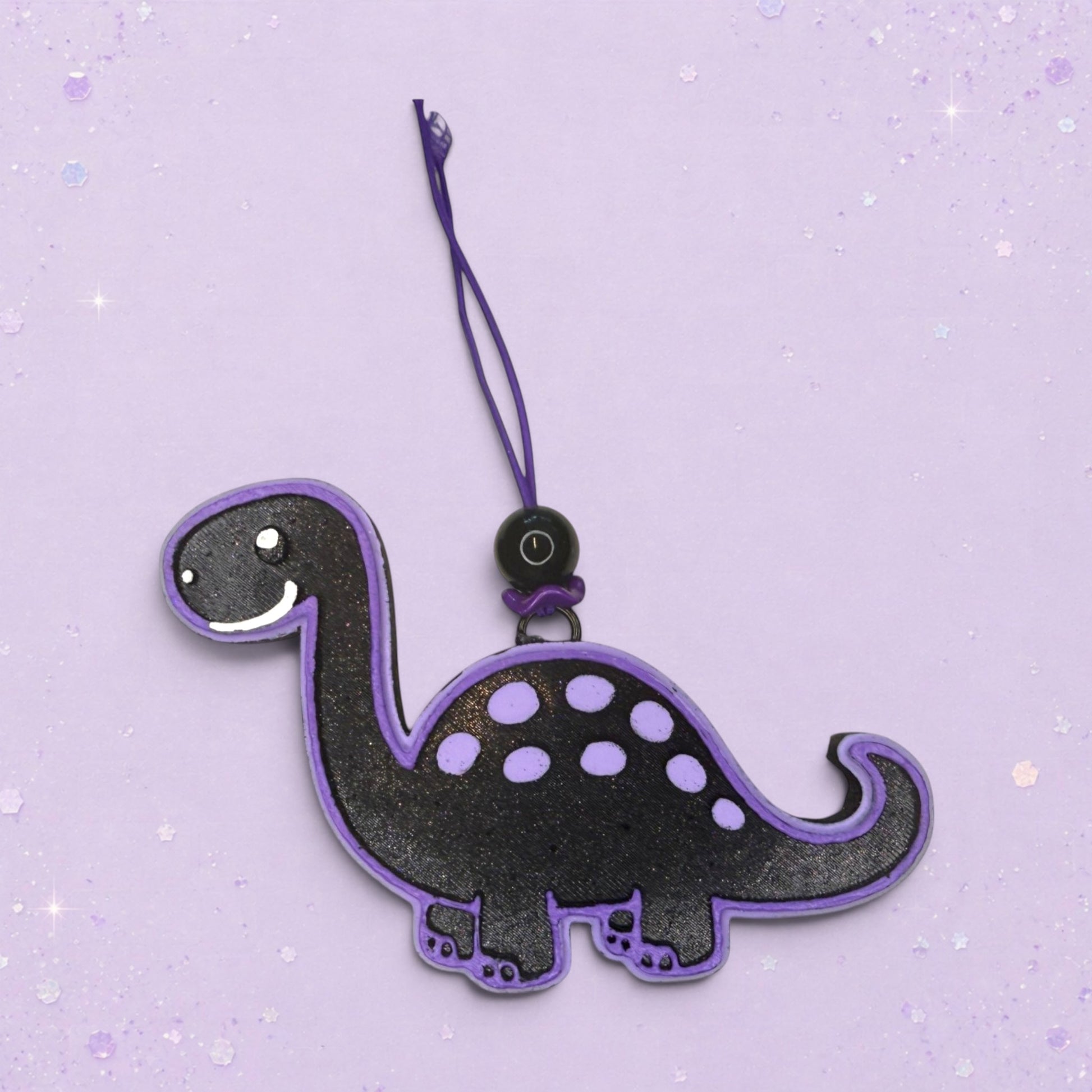 BeFreshie black dinosaur freshie with purple trim and polka dots, featuring a hanging loop and string.