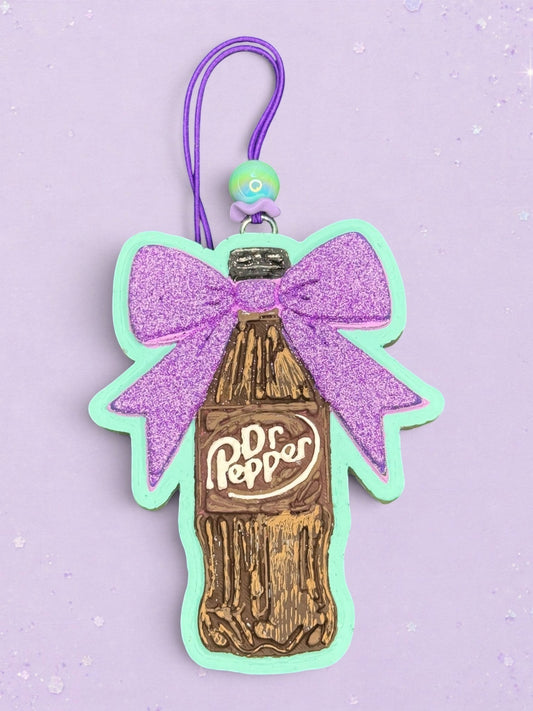 BeFreshie Dr Pepper bottle car freshie featuring a glittery purple bow and mint green border on a purple background.