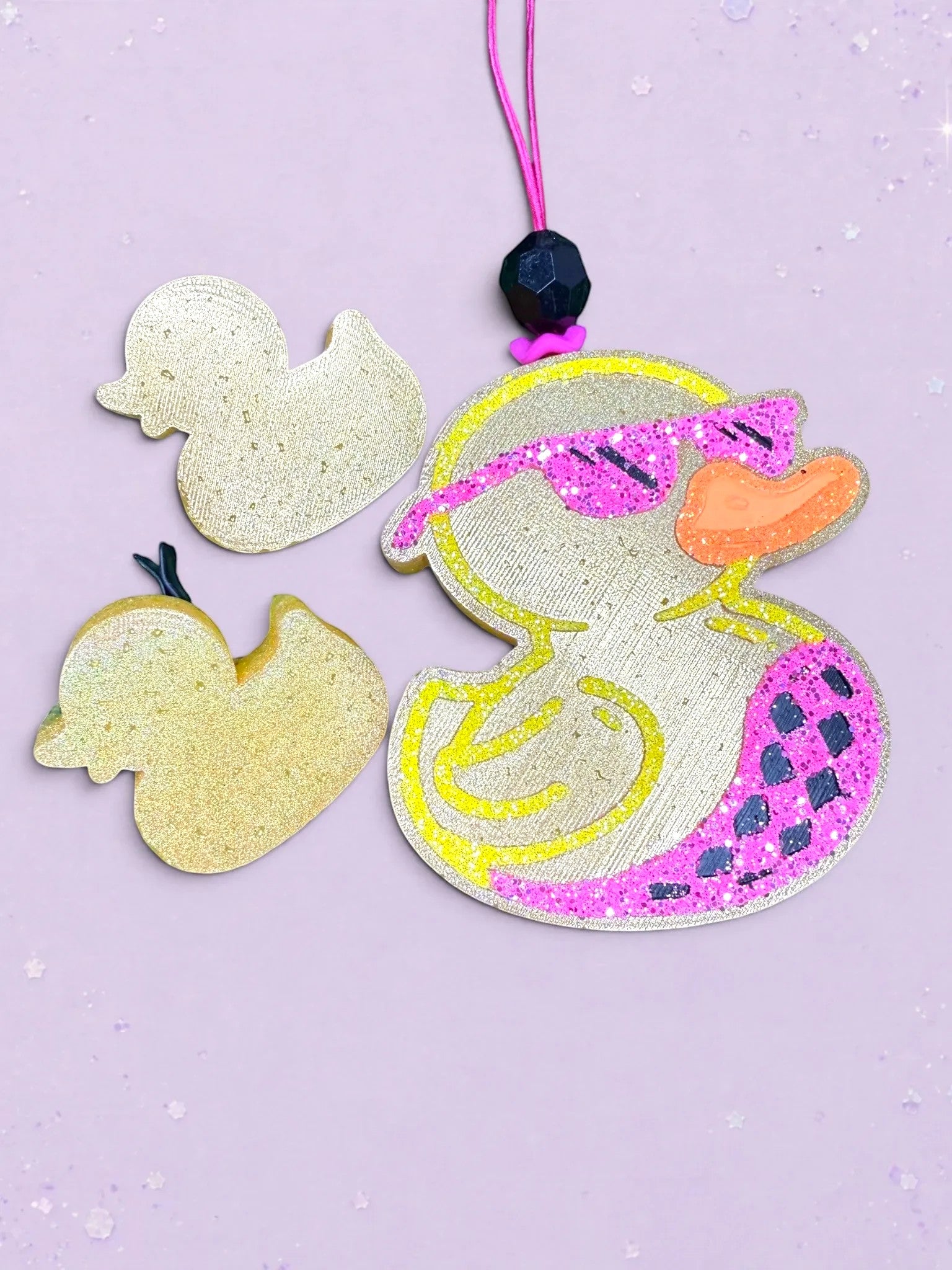 BeFreshie duck car air freshener with pink glitter sunglasses and patterned wing on a light purple background