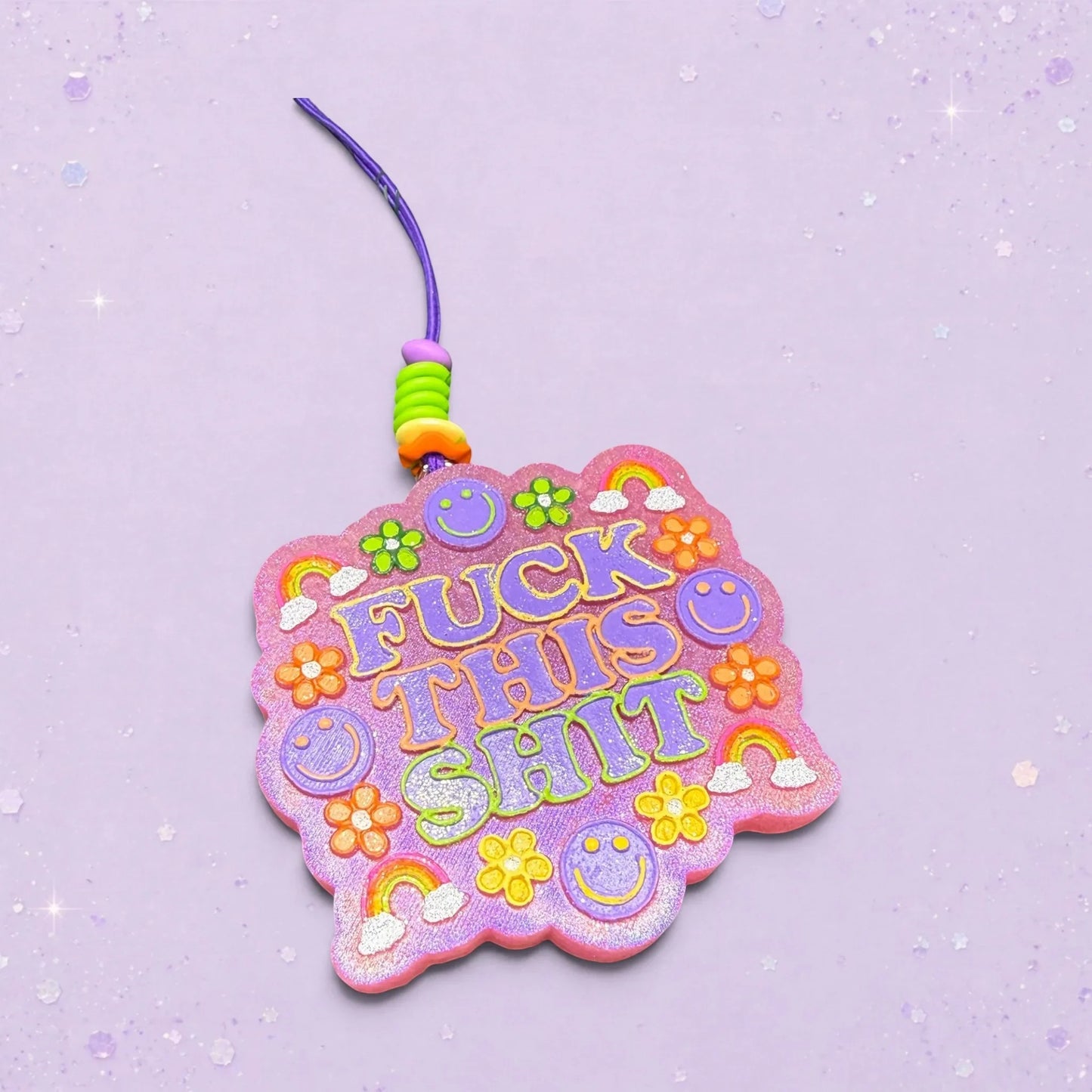 BeFreshie Fuck This Shit freshie with purple text, smiley faces, flowers, and rainbows on a glittery pink background.