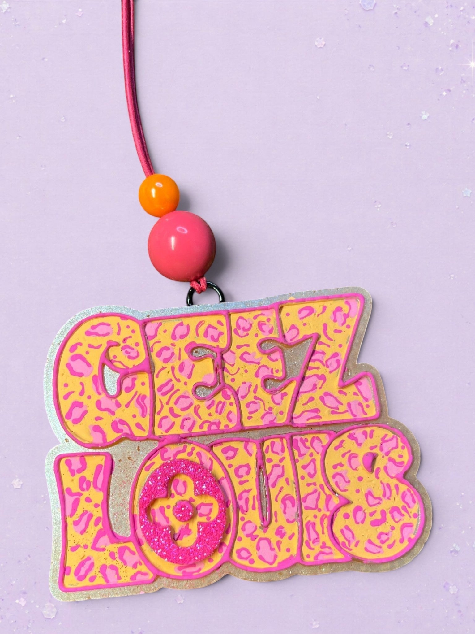 BeFreshie Geez Louis car air freshener featuring a yellow and pink leopard print design with a glittery pink logo.