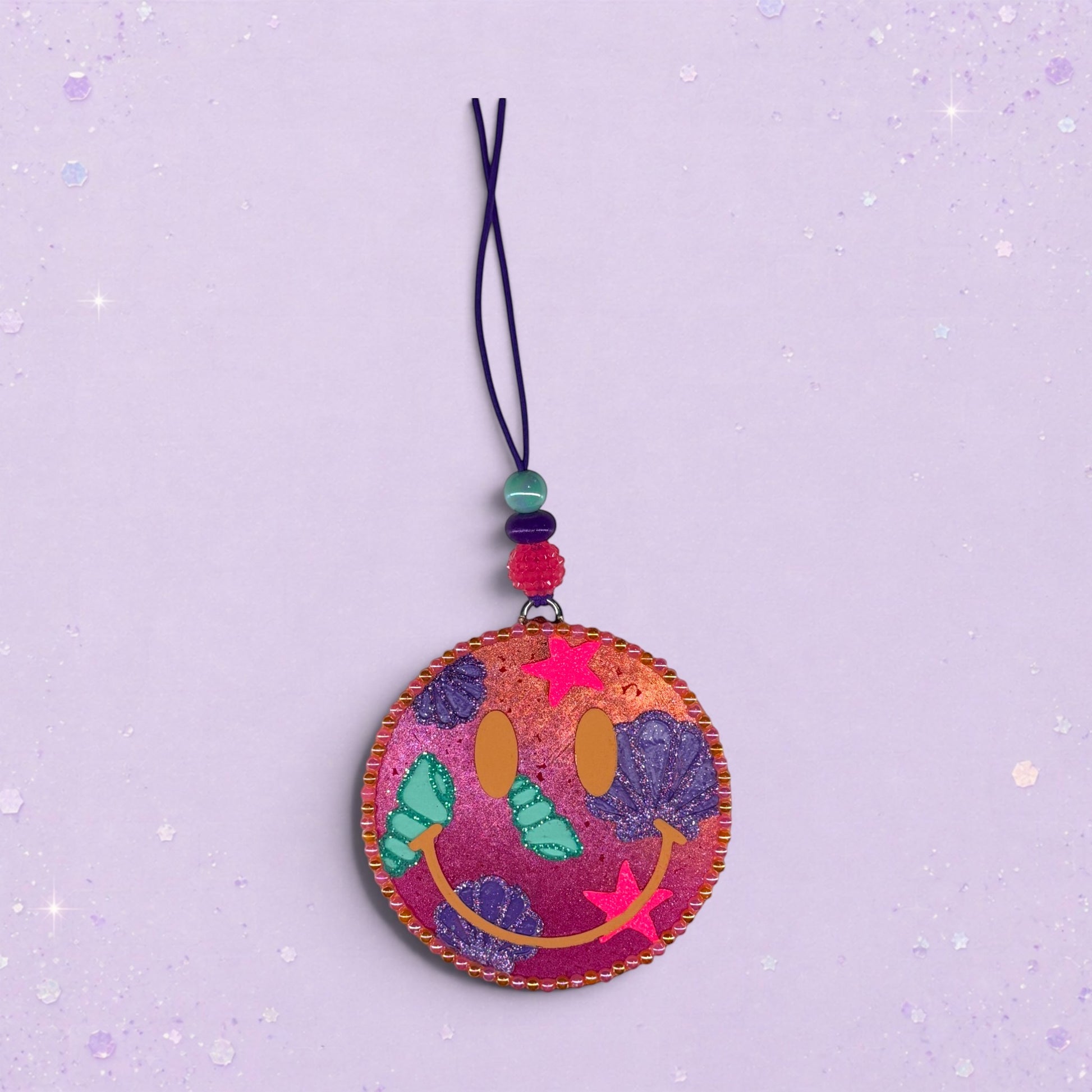 BeFreshie Happy Face Shells freshie with pink and purple swirls, shells, and stars. Features a beaded string.