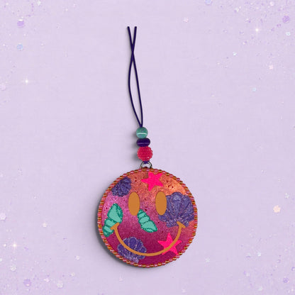 BeFreshie Happy Face Shells freshie with pink and purple swirls, shells, and stars. Features a beaded string.