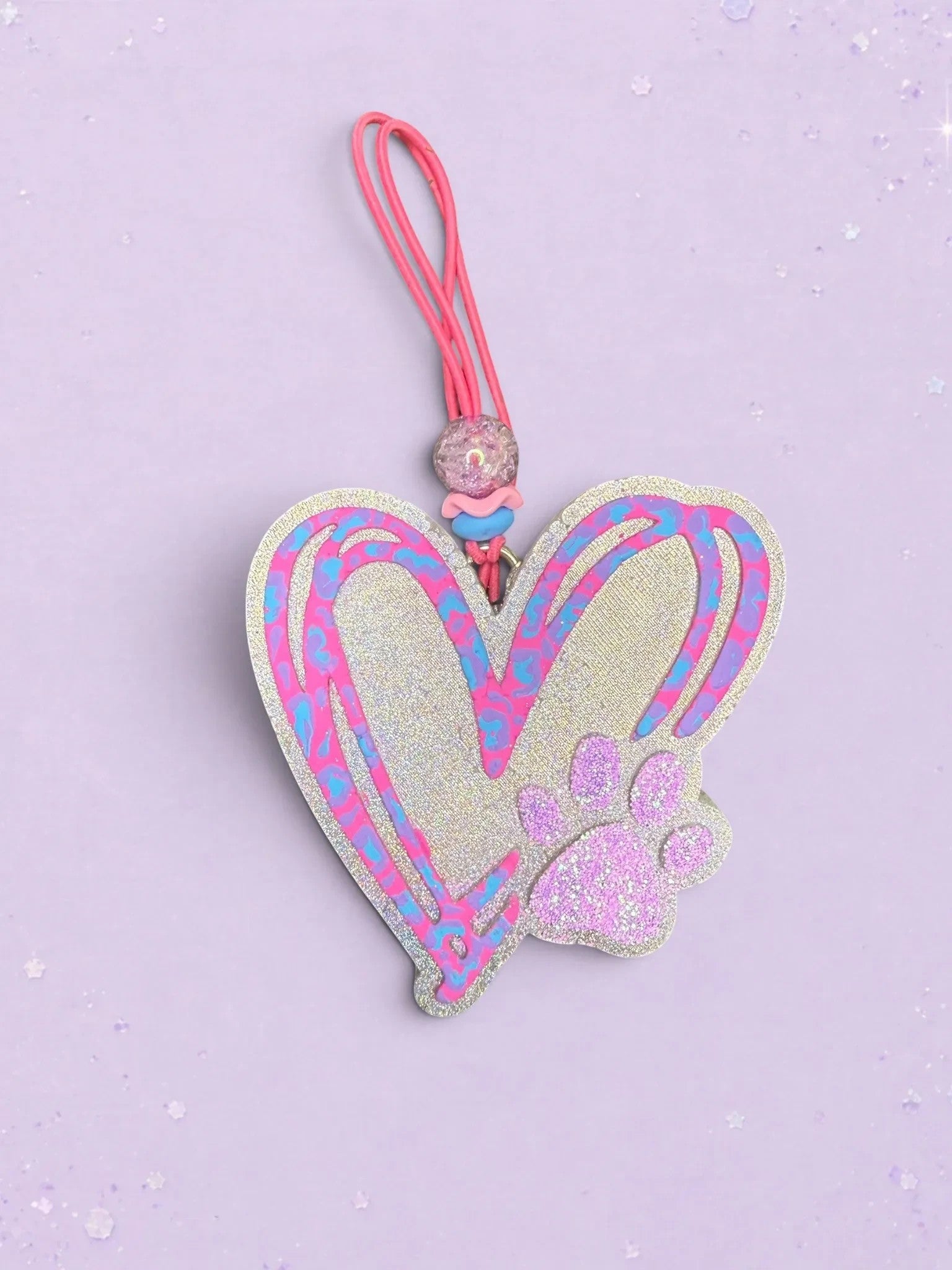 BeFreshie heart-shaped car air freshener with a glittery finish, pink paw print, and blue and pink doodle accents.