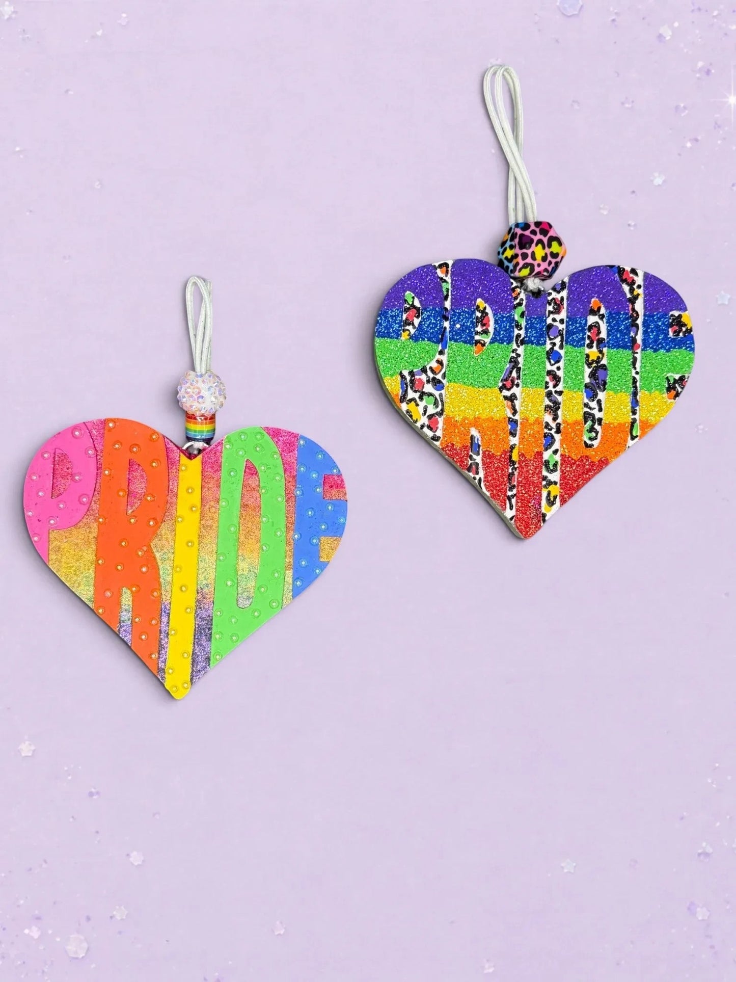 BeFreshie Heart PRIDE freshies featuring rainbow glitter, leopard print accents, and decorative beads on a purple background.