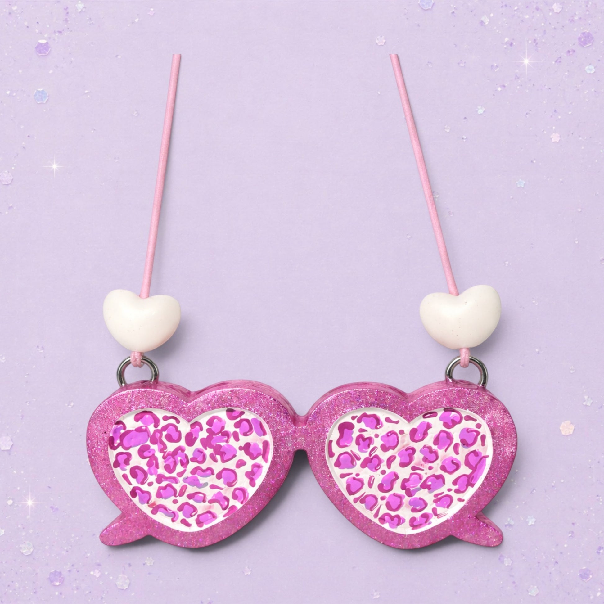 BeFreshie pink glitter heart-shaped sunglasses with leopard print lenses and white heart charms.