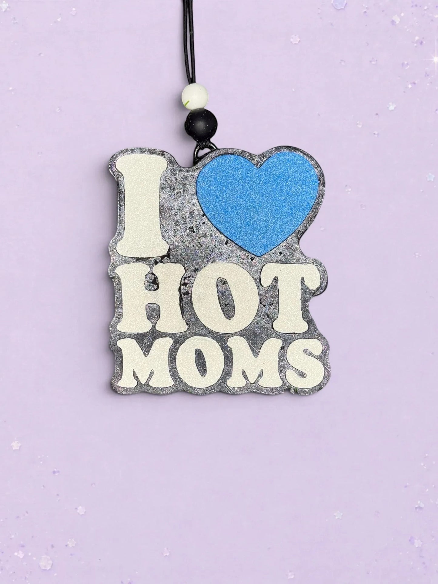 BeFreshie I Love Hot Moms car air freshener with a blue heart and glittery grey textured background on a string.