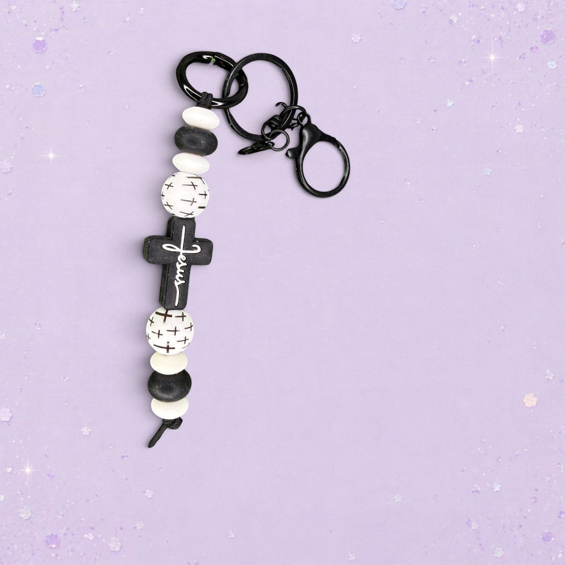 BeFreshie handmade beaded keychain with black cross charm that says "Jesus", black and white beads, and silver hardware.