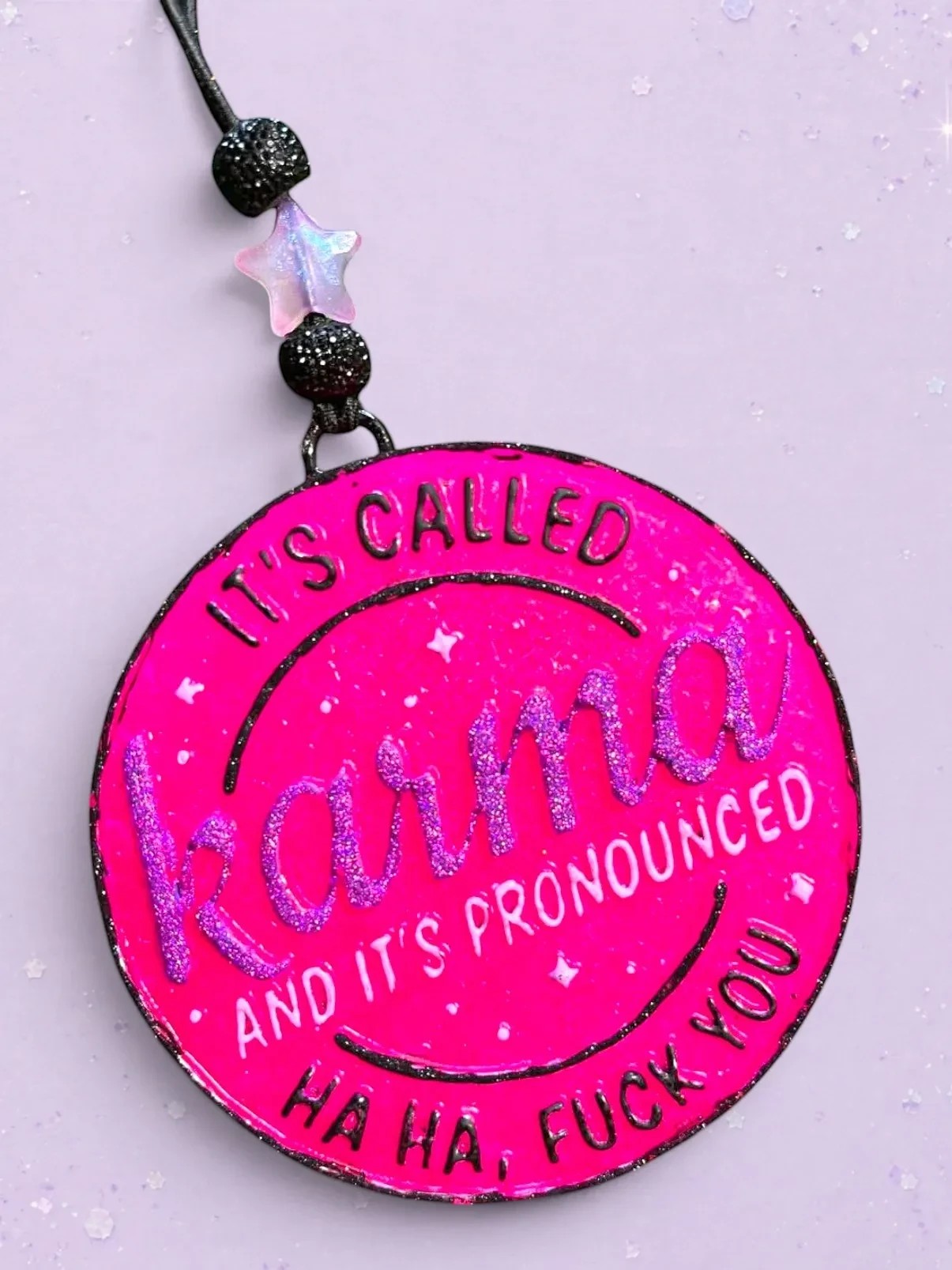 BeFreshie bright pink circular car freshie with glitter text reading "It's Called Karma And It's Pronounced Ha Ha, Fuck You".