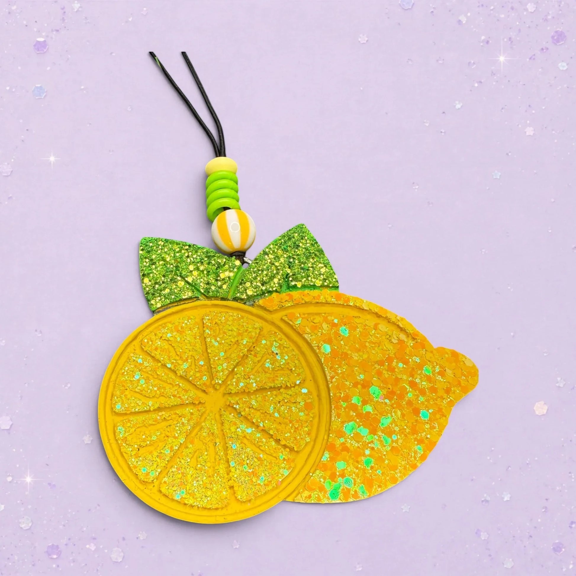 BeFreshie yellow glitter lemon slice and whole lemon car freshie with green bow and beaded hanger.