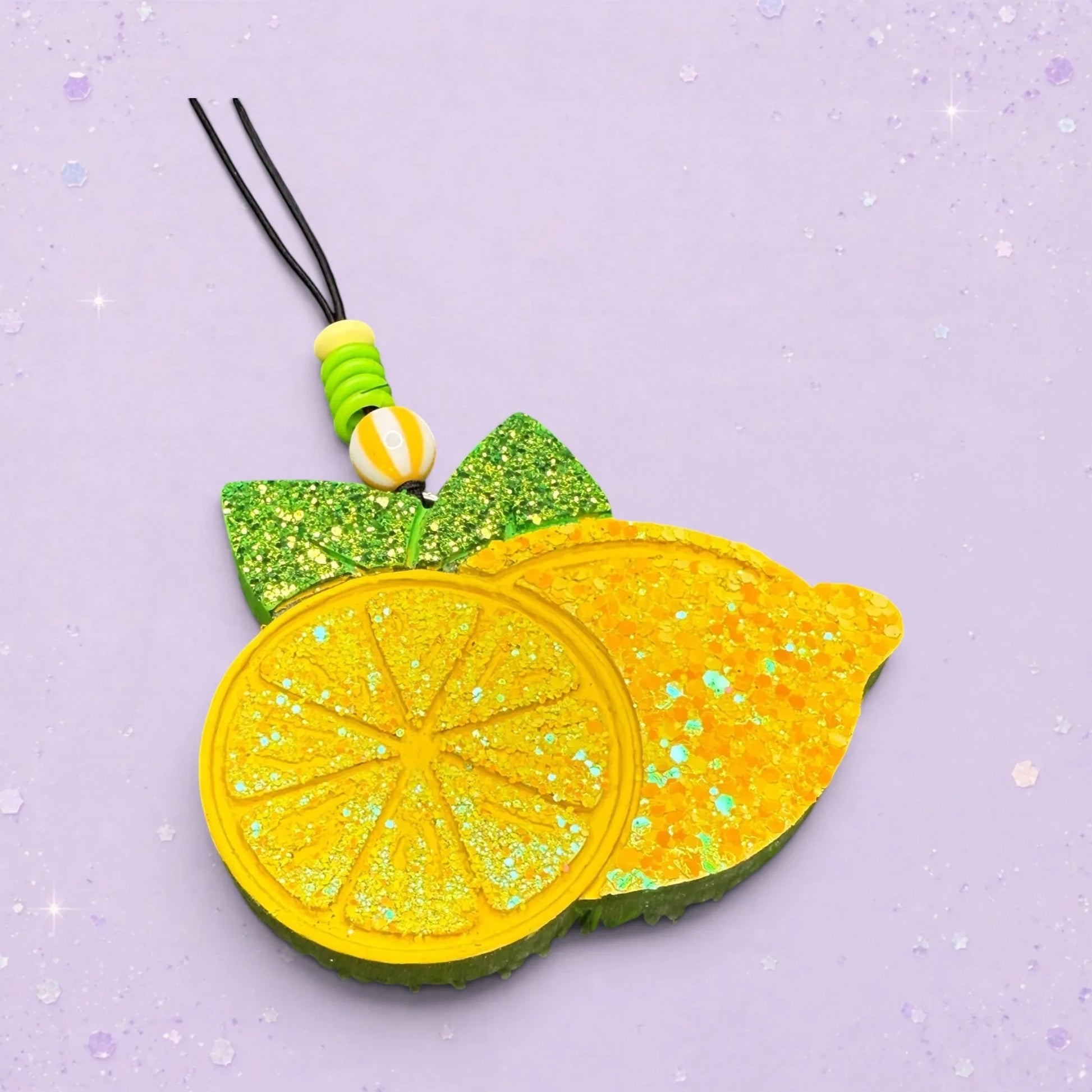 BeFreshie lemon freshie with glitter accents and green leaves. Features a lemon slice and a whole lemon.