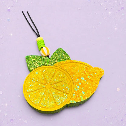 BeFreshie lemon freshie with glitter accents and green leaves. Features a lemon slice and a whole lemon.