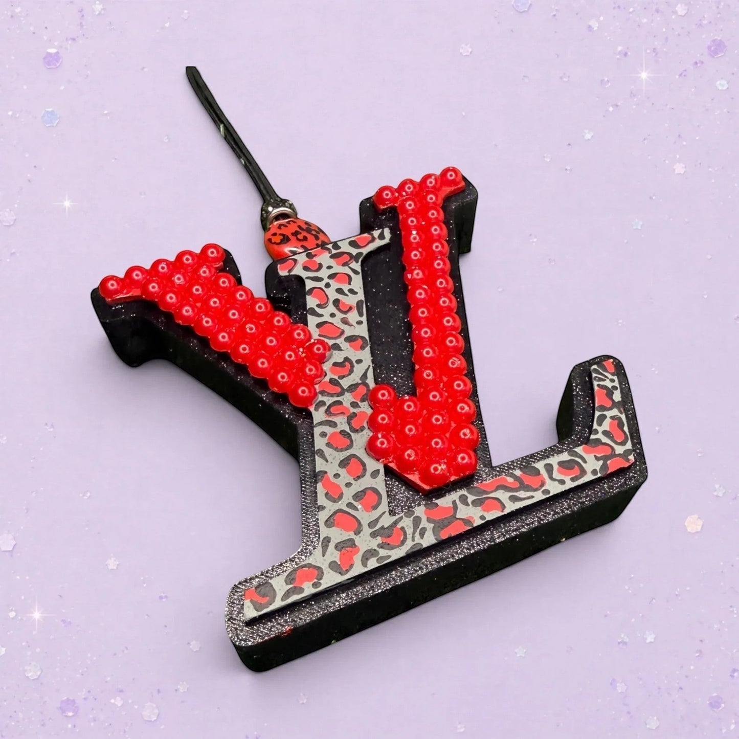BeFreshie LV freshie with black trim, red beaded accents, and leopard print detail. Adds personality.