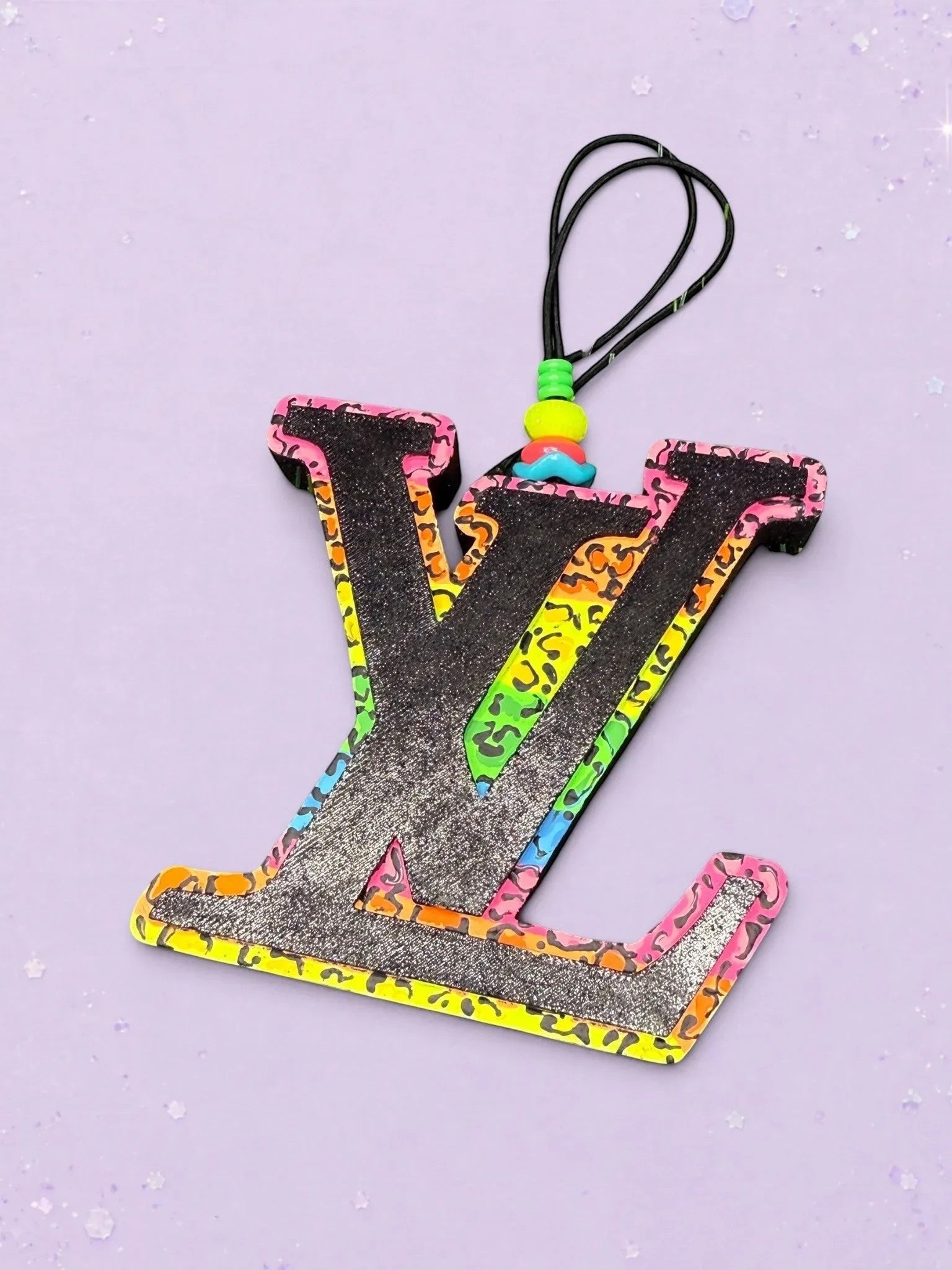 BeFreshie LV freshie car air freshener featuring a black glitter logo with a neon leopard print border and beads.