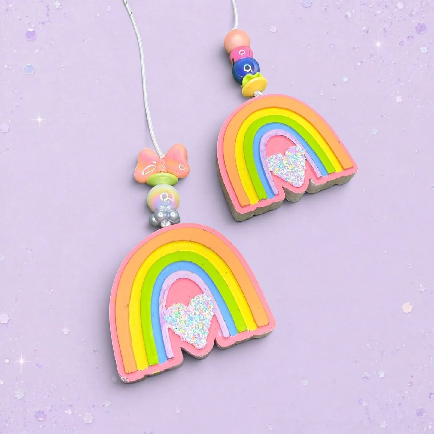 BeFreshie mini rainbow car freshies with glitter hearts and Whirly Curlz clips on a light purple background