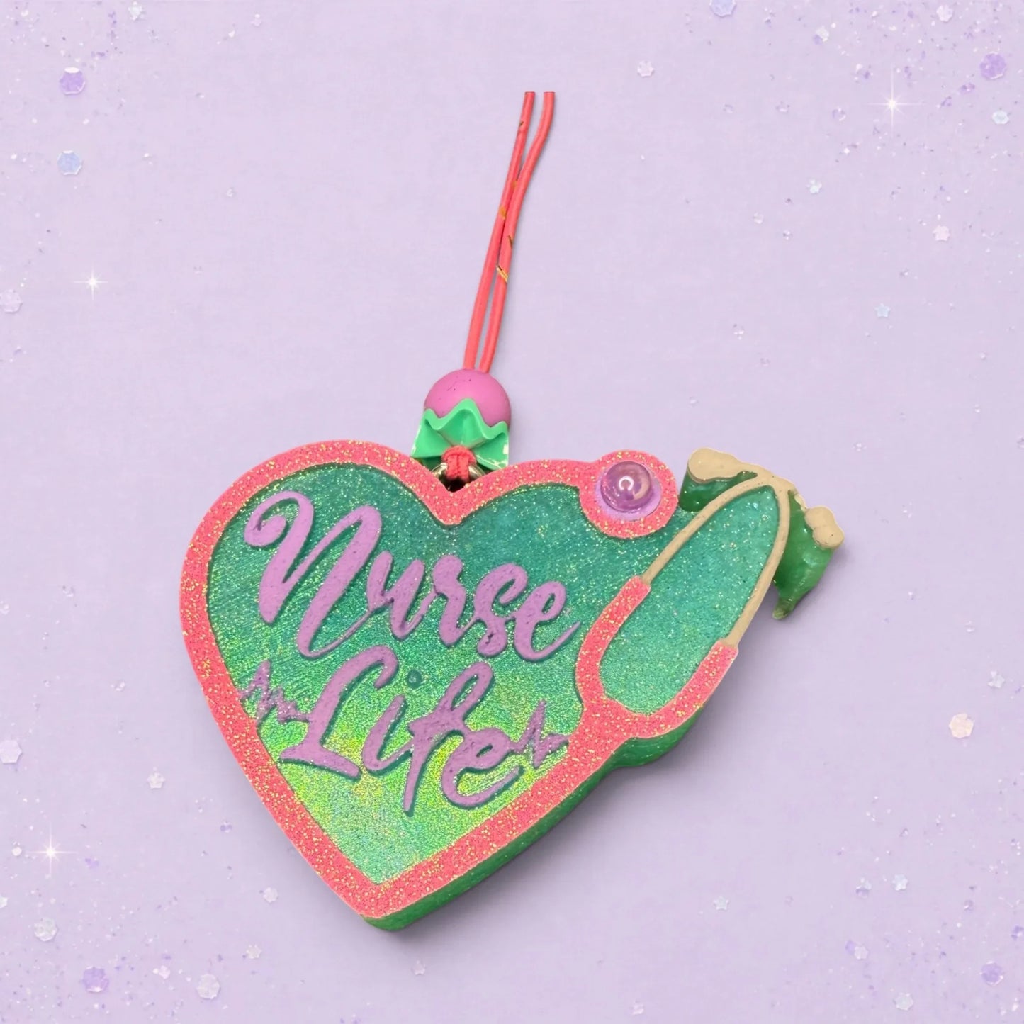 BeFreshie heart-shaped nurse life freshie with stethoscope design, pink glitter trim, green and purple lettering.
