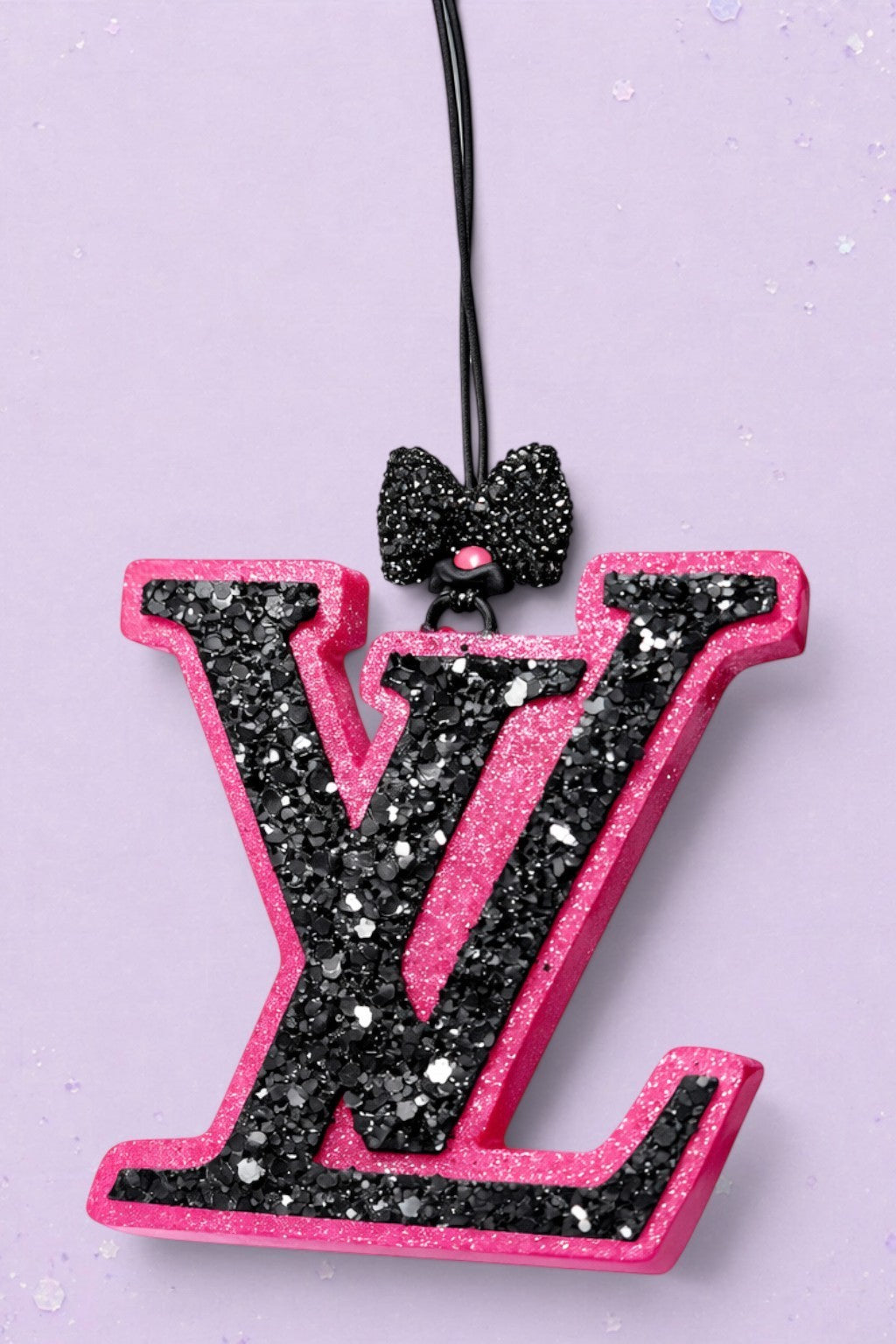 BeFreshie LV freshie car air freshener in pink and black glitter with a decorative black bow on a purple background
