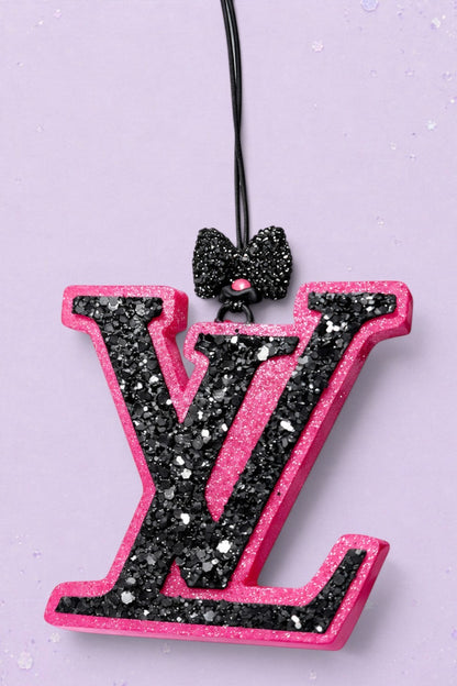 BeFreshie LV freshie car air freshener in pink and black glitter with a decorative black bow on a purple background