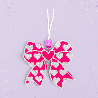 BeFreshie pink bow freshie with white hearts and a sparkly bead accent.