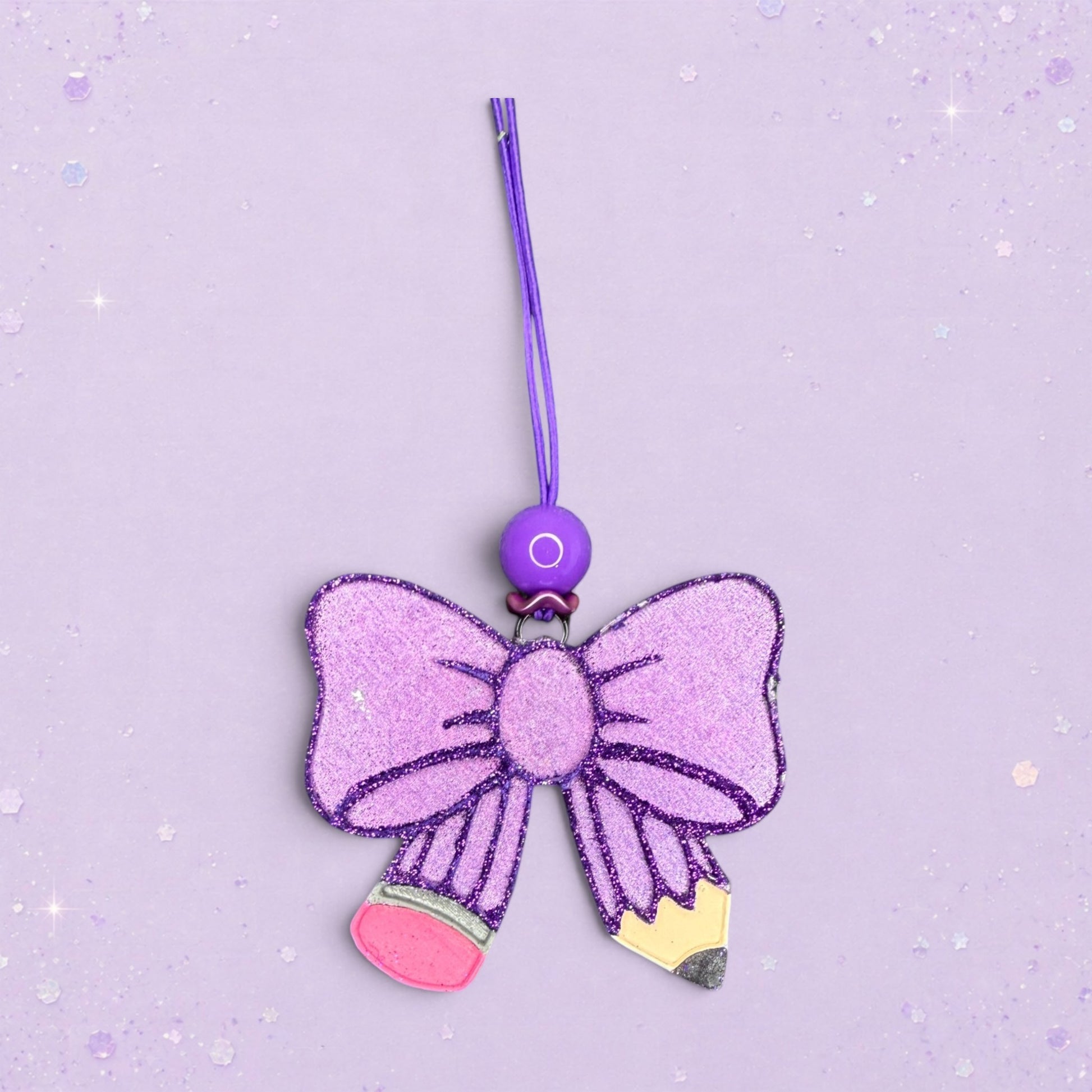 BeFreshie purple glitter bow shaped pencil freshie with pink and yellow pencil tip details.