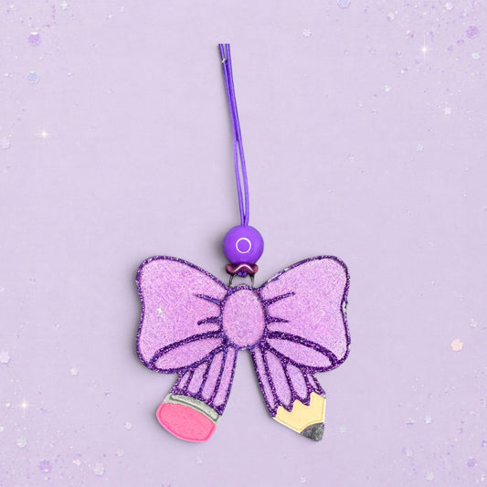 BeFreshie purple glitter bow shaped pencil freshie with pink and yellow pencil tip details.