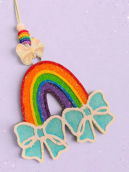 BeFreshie rainbow freshie with glittery blue bows and beaded string. Feminine car charm.