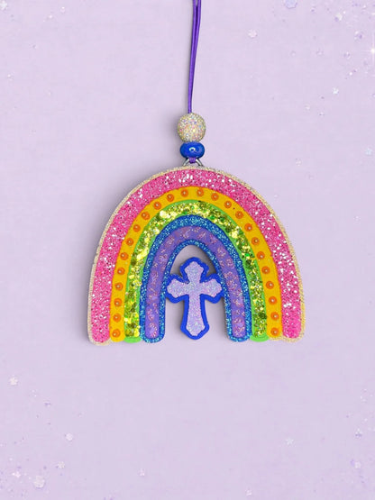 BeFreshie rainbow and cross car freshie with vibrant glittery stripes and a purple hanging cord on a lilac background