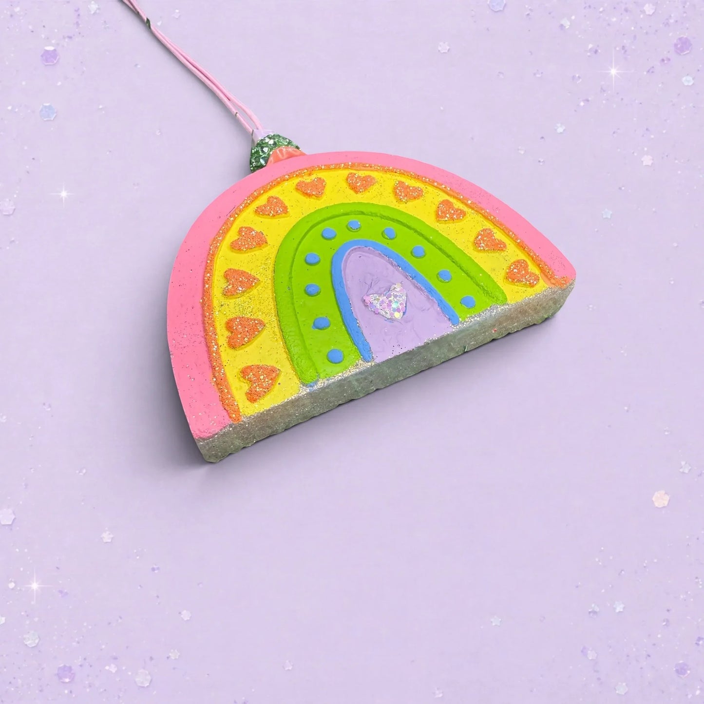 BeFreshie Rainbow Medium freshie with vibrant heart patterns and glitter accents on a light purple background