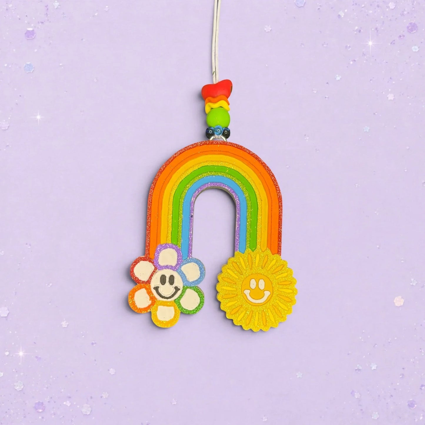 BeFreshie rainbow car freshie with a smiley flower and sun, featuring a Fruit Loops scent and colorful beads.
