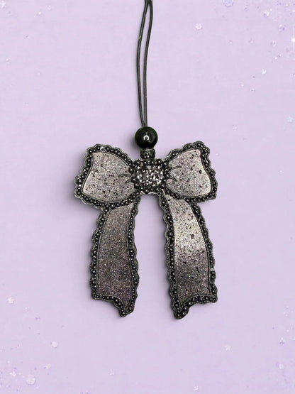 BeFreshie Scallop Bow long tails car freshie in shimmering black with beaded edges and a black hanging cord.