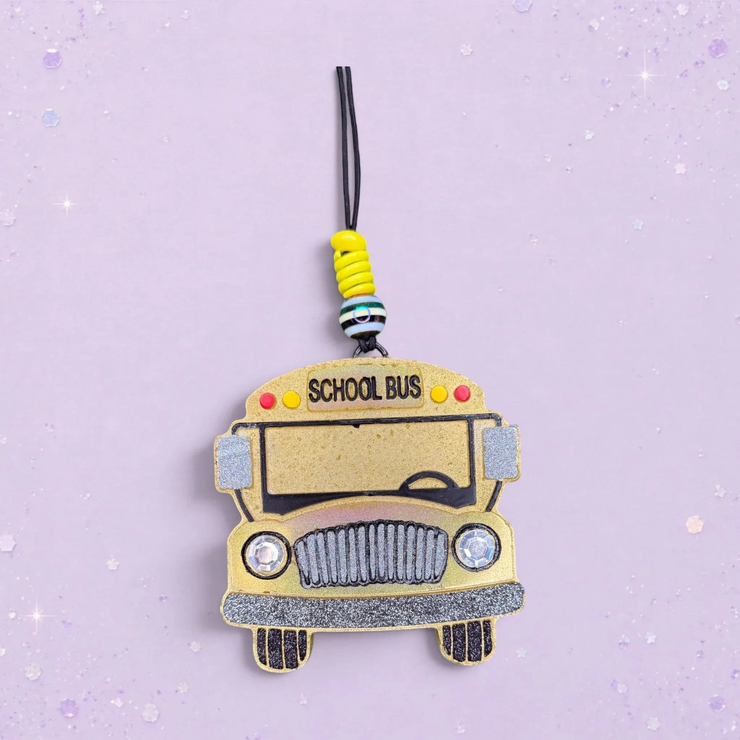BeFreshie yellow school bus freshie with glitter accents and "SCHOOL BUS" text. Features decorative beads.