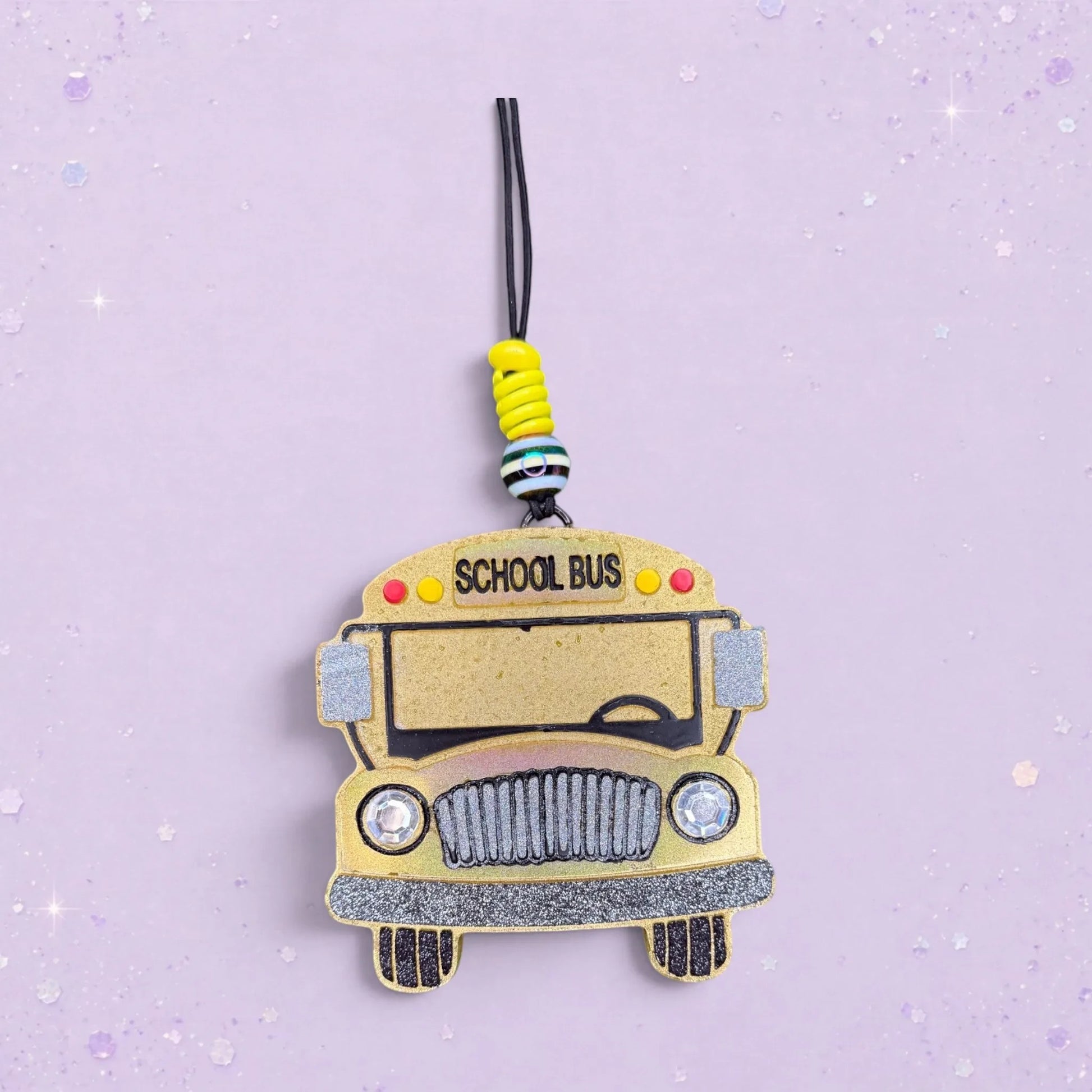 BeFreshie yellow school bus freshie with glitter accents and "SCHOOL BUS" text. Features decorative beads.