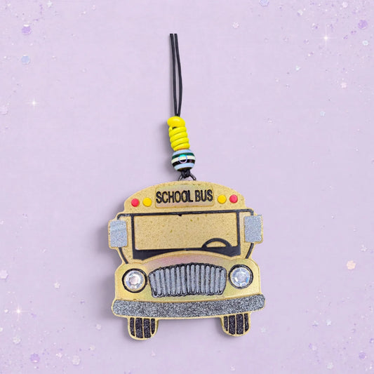 BeFreshie yellow school bus freshie with glitter accents and "SCHOOL BUS" text. Features decorative beads.