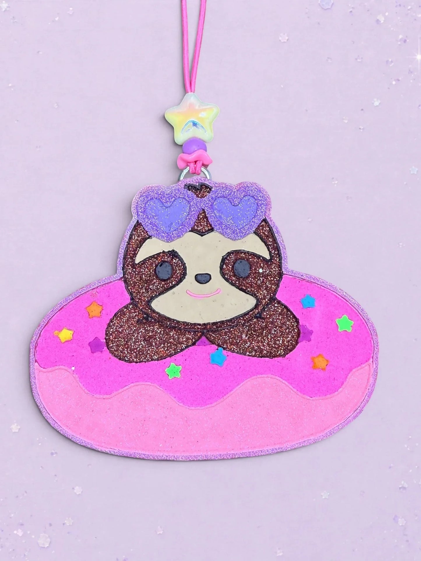 BeFreshie sloth on a pink donut pool float car air freshener with glittery purple heart sunglasses and star bead