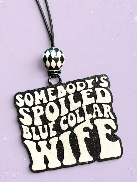 BeFreshie Somebody’s Spoiled Blue Collar Wife car air freshener with black glitter and white text.