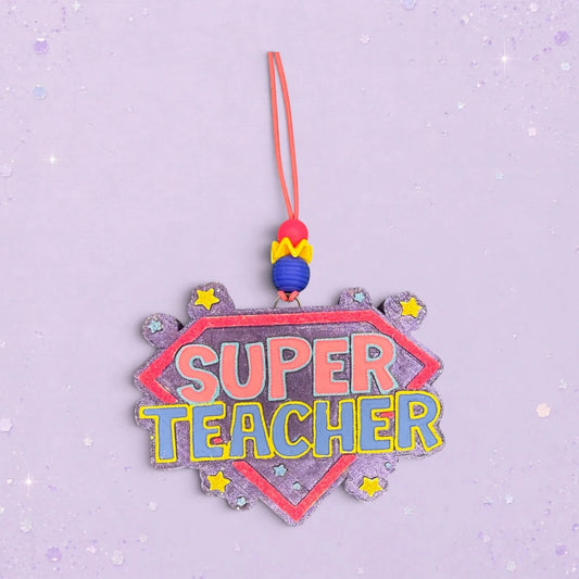 BeFreshie Super Teacher freshie ornament with pink and blue lettering on a purple glitter shield, adorned with yellow stars.