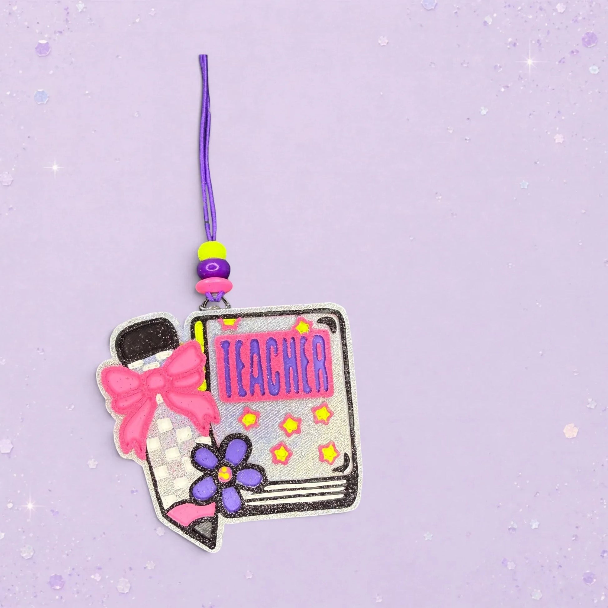 BeFreshie Teacher notebook freshie with checkered pencil, pink bow, and purple flower. Glittery silver.