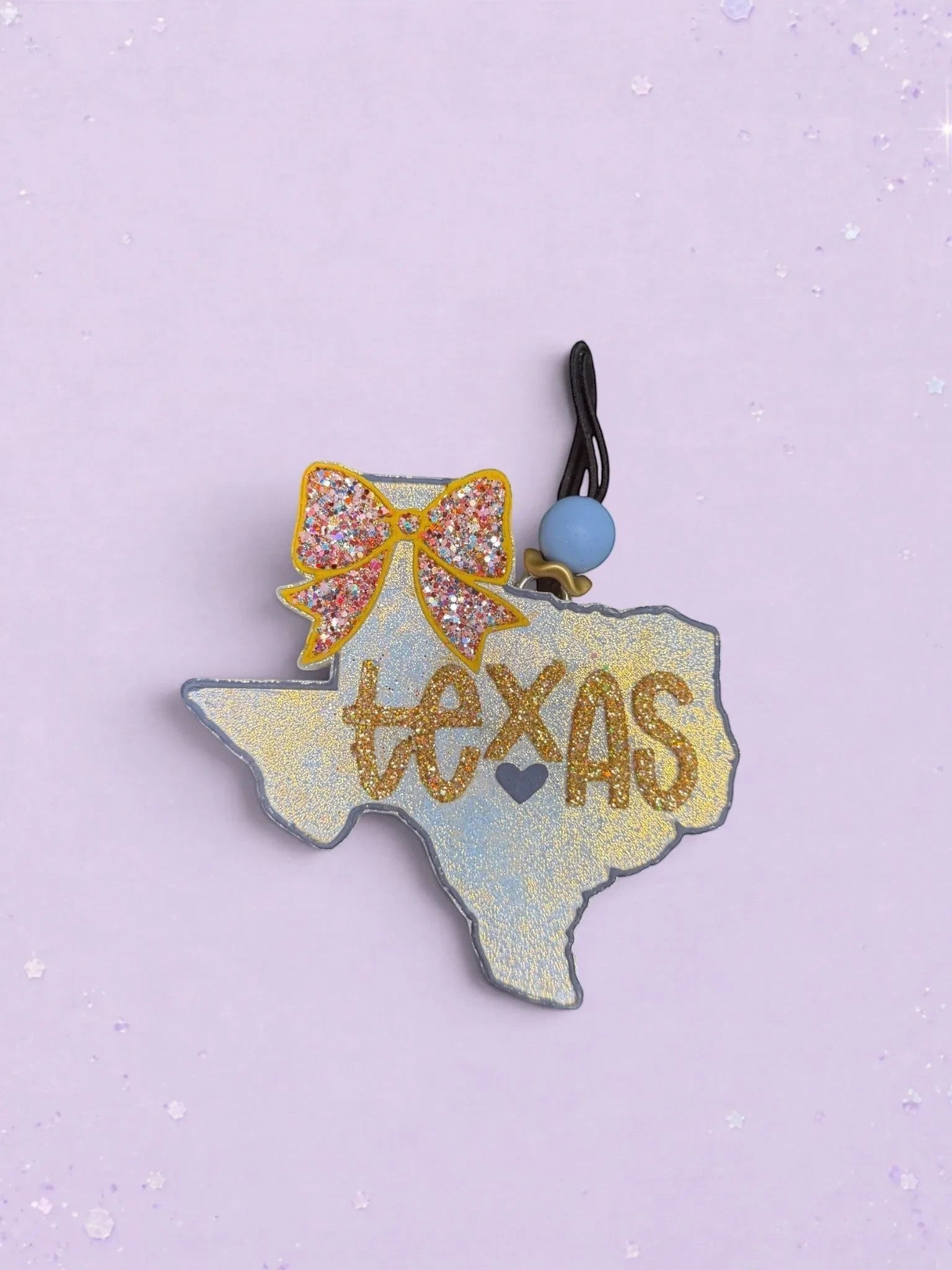 BeFreshie Texas shaped car air freshener with a glittery gold bow and script text on a light blue background.