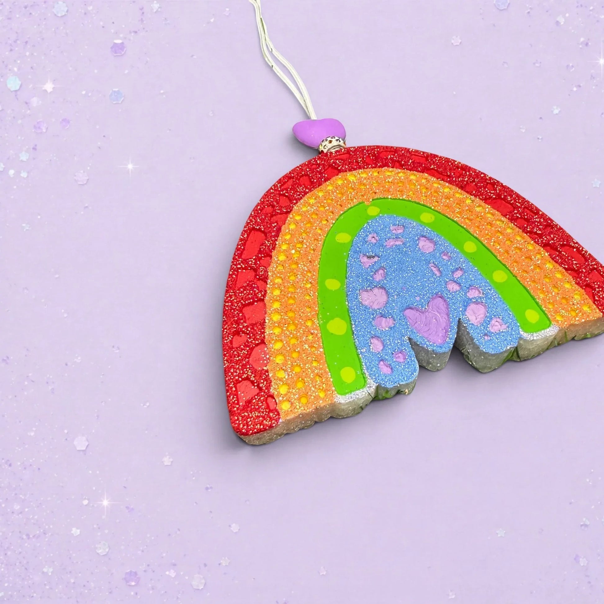 BeFreshie textured rainbow car freshie in vibrant colors with glitter accents and a purple heart bead on a lilac base
