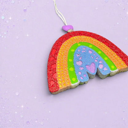 BeFreshie textured rainbow car freshie in vibrant colors with glitter accents and a purple heart bead on a lilac base
